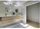 Bright bathroom featuring a double vanity with a light wood cabinet and modern sinks at 6094 Chisolm Rd, Johns Island, SC 29455