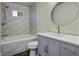 Updated bathroom with a tub-shower combo, gray wave tile, and a vanity with dark hardware at 6094 Chisolm Rd, Johns Island, SC 29455