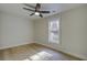 Clean, empty bedroom featuring natural light, wood floors, and a ceiling fan at 6094 Chisolm Rd, Johns Island, SC 29455