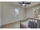Neutral Bedroom with wood floors, ceiling fan and a gray crib with natural light at 6094 Chisolm Rd, Johns Island, SC 29455