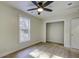 Bright bedroom with wood floors, a ceiling fan, closet, and a well-lit window at 6094 Chisolm Rd, Johns Island, SC 29455
