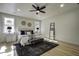 Spacious bedroom with ceiling fan, a large bed, wood floors and natural light at 6094 Chisolm Rd, Johns Island, SC 29455