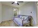 Well-lit bedroom showcasing wood floors, a ceiling fan, and a daybed with throw pillows at 6094 Chisolm Rd, Johns Island, SC 29455