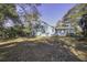 Exterior of a charming blue home featuring mature shade trees and large backyard at 6094 Chisolm Rd, Johns Island, SC 29455
