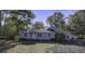 Charming single story home with light blue siding and mature trees on a large lot at 6094 Chisolm Rd, Johns Island, SC 29455