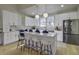 Modern kitchen with white cabinets, island with seating, and stainless steel appliances at 6094 Chisolm Rd, Johns Island, SC 29455