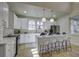 Modern kitchen with a large island, seating, pendant lighting, and stainless appliances at 6094 Chisolm Rd, Johns Island, SC 29455