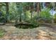 Charming backyard pond with a stone surround, creating a serene outdoor oasis at 6094 Chisolm Rd, Johns Island, SC 29455