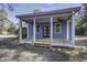 Inviting covered porch with double doors, white columns, and ceiling fans for outdoor comfort at 6094 Chisolm Rd, Johns Island, SC 29455
