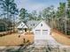 New construction home featuring three-car garage, green lawn and sidewalks at 64 Piedmont Rd, Walterboro, SC 29488