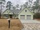 Attractive light green home with an attached two-car garage and landscaped front yard at 64 Piedmont Rd, Walterboro, SC 29488