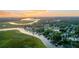 Stunning aerial view of a waterfront neighborhood at sunset, showcasing homes with private docks at 6917 Tanner Hall Blvd, Hanahan, SC 29410
