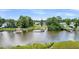 Aerial view of waterfront homes with private docks on a serene river, surrounded by lush trees at 6917 Tanner Hall Blvd, Hanahan, SC 29410