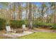 Fire pit and chairs, ready for outdoor relaxation among mature trees in the spacious yard at 6917 Tanner Hall Blvd, Hanahan, SC 29410