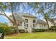 Backyard view of the property featuring well-maintained landscaping, mature trees, and deck at 6917 Tanner Hall Blvd, Hanahan, SC 29410