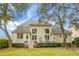 Expansive backyard shows lush green lawn, mature trees, deck and patio with outdoor seating at 6917 Tanner Hall Blvd, Hanahan, SC 29410