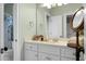 Bathroom featuring a pristine white vanity, a large mirror, and soft green walls at 6917 Tanner Hall Blvd, Hanahan, SC 29410