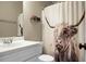 Bathroom with a single sink vanity and quirky highland cow shower curtain at 6917 Tanner Hall Blvd, Hanahan, SC 29410