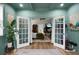 View through double doors into bedroom with ensuite and elegant furnishings at 6917 Tanner Hall Blvd, Hanahan, SC 29410