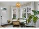 Cozy breakfast nook featuring a built-in bench, decorative lighting, large windows and a round table at 6917 Tanner Hall Blvd, Hanahan, SC 29410