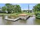 Overhead shot of a wooden dock with a covered area and walkway, set against a lush green lawn at 6917 Tanner Hall Blvd, Hanahan, SC 29410