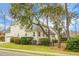 Exterior view of the property featuring well-maintained landscaping and mature trees at 6917 Tanner Hall Blvd, Hanahan, SC 29410