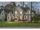 Charming two-story home with well-manicured lawn and mature trees creating a peaceful and inviting atmosphere at 6917 Tanner Hall Blvd, Hanahan, SC 29410