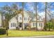 Attractive two-story home featuring manicured lawn and a classic architectural style with symmetrical windows at 6917 Tanner Hall Blvd, Hanahan, SC 29410