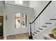 Bright foyer with staircase, double doors with sidelights, and wood flooring offering a welcoming entrance at 6917 Tanner Hall Blvd, Hanahan, SC 29410