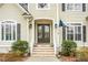 Welcoming front entrance with double doors, decorative plants, and prominent house number on the steps at 6917 Tanner Hall Blvd, Hanahan, SC 29410