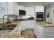 Modern kitchen with granite counters, an island, double basin sink, and stainless appliances at 6917 Tanner Hall Blvd, Hanahan, SC 29410
