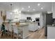 Well-lit kitchen area with granite countertops, bar seating, an island and modern appliances at 6917 Tanner Hall Blvd, Hanahan, SC 29410