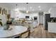 Well-lit kitchen area with granite countertops, bar seating, an island and modern appliances at 6917 Tanner Hall Blvd, Hanahan, SC 29410