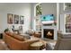 Open-plan living room with high ceilings, a fireplace, and large windows for natural light at 6917 Tanner Hall Blvd, Hanahan, SC 29410