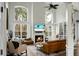 Bright living room with large windows, fireplace, and built-in shelves at 6917 Tanner Hall Blvd, Hanahan, SC 29410