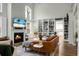 Inviting living room with built-in shelving, fireplace, and open layout to the kitchen at 6917 Tanner Hall Blvd, Hanahan, SC 29410