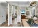 Spacious open living space with dining table and a cozy living room featuring large windows and a fireplace at 6917 Tanner Hall Blvd, Hanahan, SC 29410