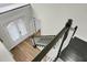 Staircase with dark steps, decorative railing, and natural light at 6917 Tanner Hall Blvd, Hanahan, SC 29410