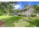 Well-manicured backyard with lush green lawn, screened porch, and mature trees at 6934 Tanner Hall Blvd, Hanahan, SC 29410