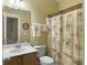 A cozy bathroom with a palm tree-themed shower curtain, towels, and decor at 6934 Tanner Hall Blvd, Hanahan, SC 29410