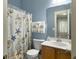 Nautical-themed full bathroom featuring blue walls, patterned shower curtain, and white towels at 6934 Tanner Hall Blvd, Hanahan, SC 29410