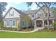 Charming two-story home with inviting front porch and beautifully landscaped front yard at 6934 Tanner Hall Blvd, Hanahan, SC 29410