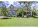 Inviting two-story home featuring a well-manicured lawn and mature landscaping, enhancing its curb appeal at 6934 Tanner Hall Blvd, Hanahan, SC 29410