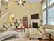 Inviting living room with fireplace, comfortable seating, and large windows for natural light at 6934 Tanner Hall Blvd, Hanahan, SC 29410
