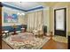 Formal living room with colorful rug, front entry and blue and neutral color scheme at 6934 Tanner Hall Blvd, Hanahan, SC 29410
