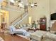 Spacious living room with hardwood floors, staircase, and elegant decor at 6934 Tanner Hall Blvd, Hanahan, SC 29410