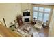 Bright living room with fireplace, large windows, comfortable furniture and a soaring ceiling at 6934 Tanner Hall Blvd, Hanahan, SC 29410