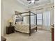Spacious main bedroom boasts a four-poster bed, soft carpet, and a tray ceiling at 6934 Tanner Hall Blvd, Hanahan, SC 29410