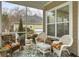 Comfortable screened-in porch featuring wicker furniture and colorful tropical accents at 6934 Tanner Hall Blvd, Hanahan, SC 29410