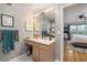Bathroom vanity with a large mirror and lighting, with view to bedroom at 700 Daniel Ellis Dr # 8304, Charleston, SC 29412